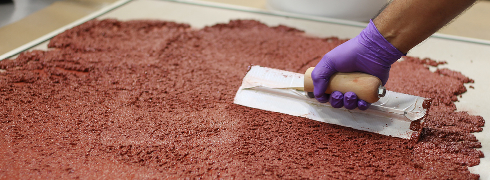 Applying resin floor by trowel.